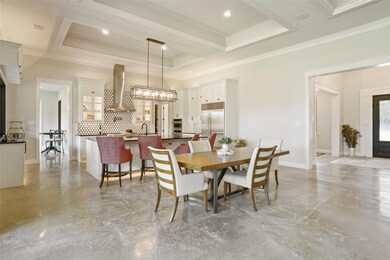 Dining area with crown molding, a raised ceiling, 