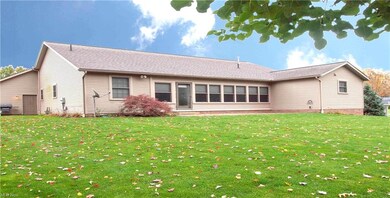 Wide, heated sun room with access to backyard.