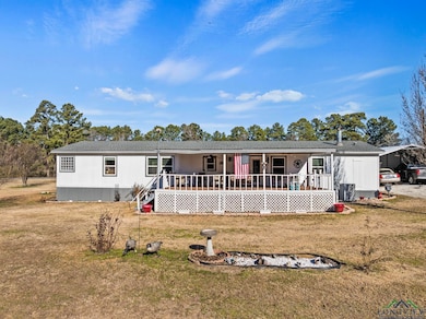View of front of property featuring a porch, a car