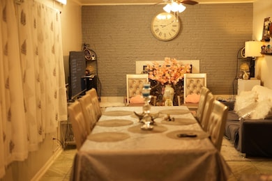 Dining space with ceiling fan, tile patterned floo
