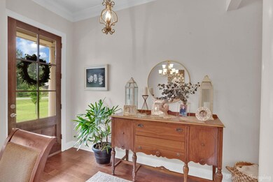 Entryway with an inviting chandelier, ornamental m