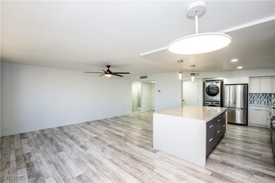 Kitchen featuring a center island, light counterto