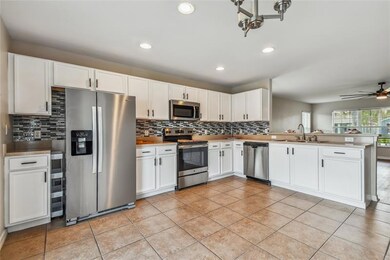 Huge, Open Kitchen with STAINLESS STEEL APPLIANCES and Breakfast Bar - opens to Living Room