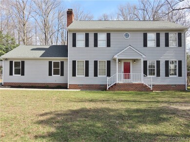 Colonial charm with a two car garage and paved dri