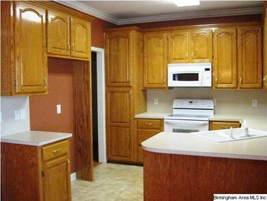 Kitchen has beautiful oak cabinets.