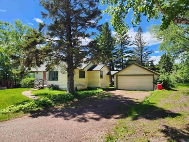 View of front of house featuring a garage and an o