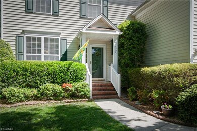 Mature landscaping decorates the front entrance
