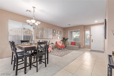 Dining area featuring light carpet, a chandelier,