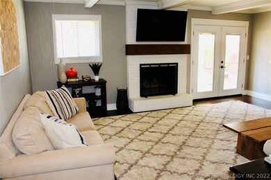 Living area with fire place and doors to covered p