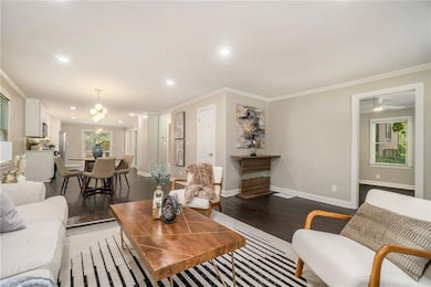 Living room featuring dark wood-style floors, orna