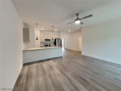 Kitchen featuring pendant lighting, white cabinetr