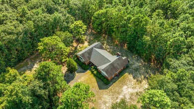 Aerial view featuring a wooded view