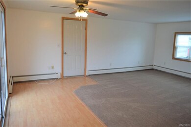 Living room with brand new carpet and sliding glas