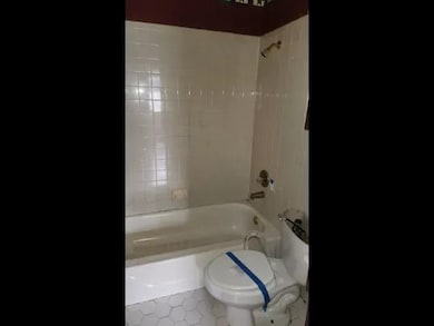 Full bath with bathing tub / shower combination and tile patterned floors