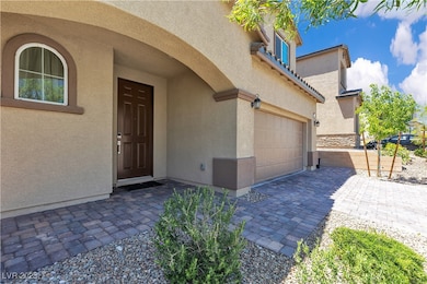 Doorway to property featuring stucco siding, a gar