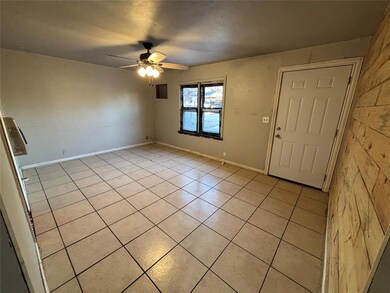Tiled foyer entrance featuring ceiling fan