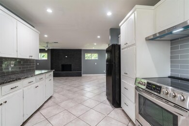 Kitchen with black refrigerator, stainless steel r