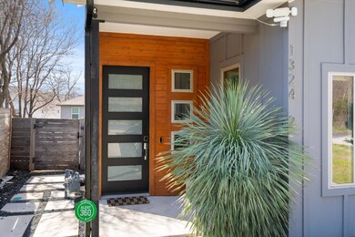 View of exterior entry with a gate, fence, and bo