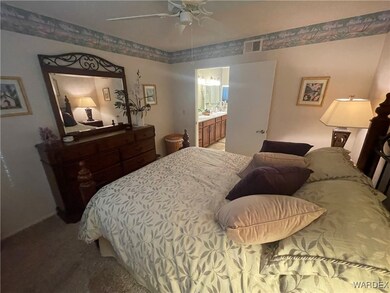 Bedroom with carpet flooring, ensuite bath, and ce