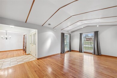 Very spacious vaulted living room features hardwoo