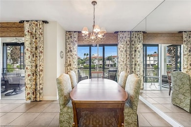 Tiled dining area featuring an inviting chandelier
