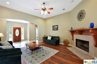 Spacious living area complete with upgraded wood floors and a wood burning fireplace