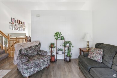 Living area with wood finished floors and stairs