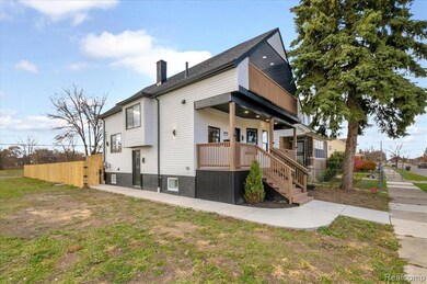 Rear view of property with covered porch, stairs, and a chimney