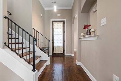Entrance foyer featuring ornamental molding and da