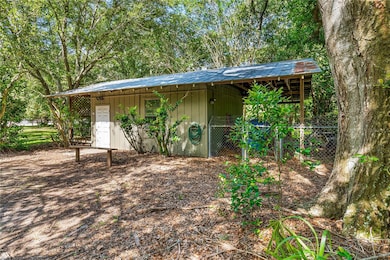 Detached workshop with covered lean-to for equipment storage