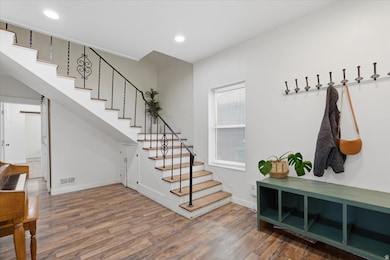 Stairs featuring wood finished floors and recessed lighting
