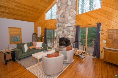 Living room with wood finished floors, high vaulte