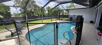 View of pool with a fenced backyard, glass enclosu