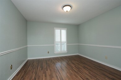 The dining room sits just of the entryway creating a welcoming atmosphere for guests when entertaining. The wooden shutters, crown molding and designer paint add elegance to the relaxed and inviting dining room.