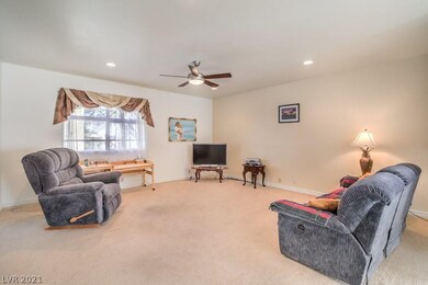 Living room with ceiling fan and recess lighting