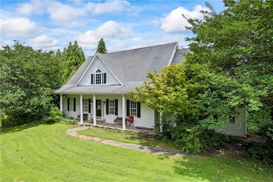 View of front of house with a porch and a front yard