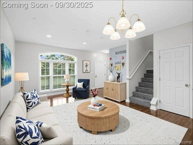 Living area with dark wood-style floors, stairs, a chandelier, and recessed lighting