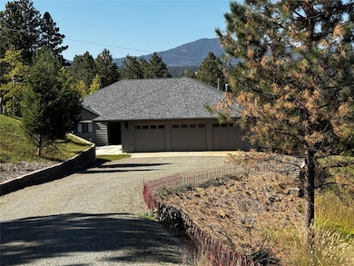 Front of House with driveway and a mountain view