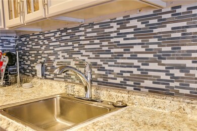 The contemporary tile backsplash works beautifully