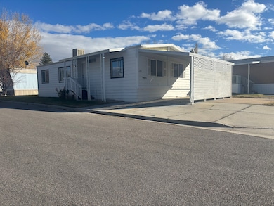 Manufactured / mobile home with a carport and concrete driveway