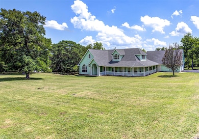 View of front facade with a porch and a front lawn