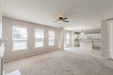 Unfurnished living room with light colored carpet, a ceiling fan, and light tile patterned flooring