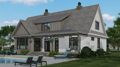 Rear view of house with board and batten siding, a patio, and a lawn