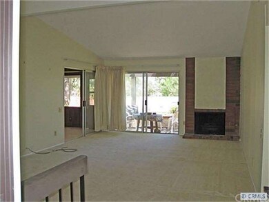 Spacious Living Room with Brick Fireplace and Cath