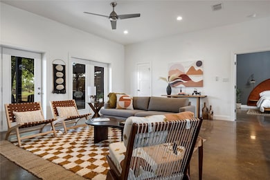 Living room with concrete floors, recessed lighting, and ceiling fan