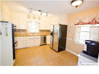 Large kitchen with tile floors, granite countertop