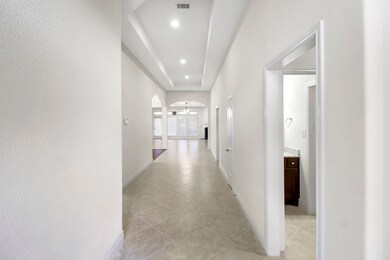 Tile Flooring as you enter the Foyer. On the right is the Home Office  than guest hall. Guest hallway offers 3 large guest bedrooms and 2 full bathrooms. Notice the same tile throughout the home.