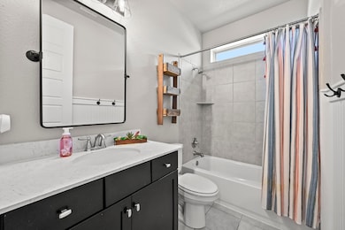 Bathroom featuring vanity, shower / tub combo wit