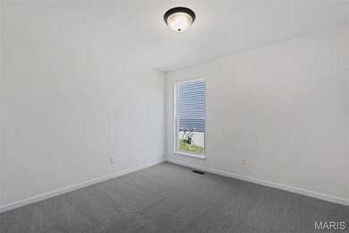 Carpeted empty room featuring baseboards