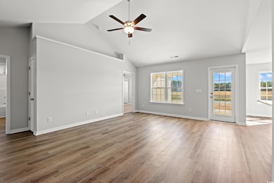 Unfurnished living room with high vaulted ceiling, light wood-type flooring, and ceiling fan